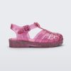 Side view of a Mini Melissa Possession baby sandal in glitter pink with velcro buckle closure on the ankle strap