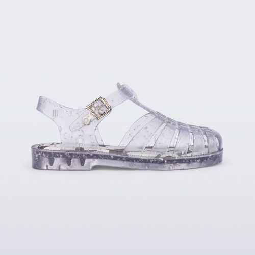 Side view of a clear Possession kids sandal with star glitter