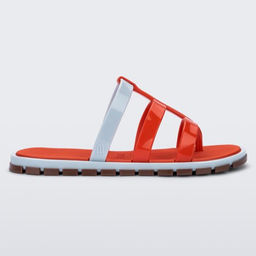 Side view of a red Path adult sandal with  blue sole