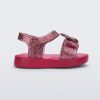 Side view of a glitter pink Mini Melissa Jump sandal with a Mickey Mouse logo detail on the front strap and an ankle strap