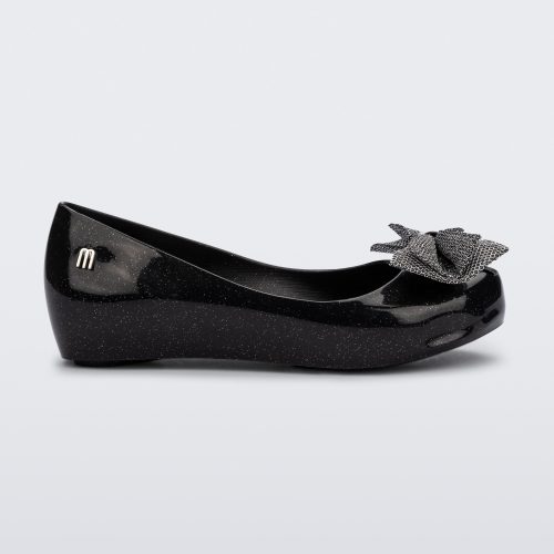 Side view of a glitter black Ultragirl Sweet kids ballerina flat with bow