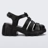 Side view of a black Megan kids heel sandal.