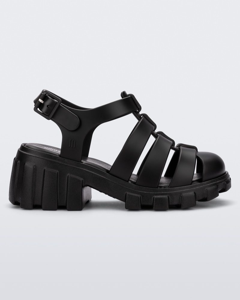 Side view of a black Megan kids heel sandal.