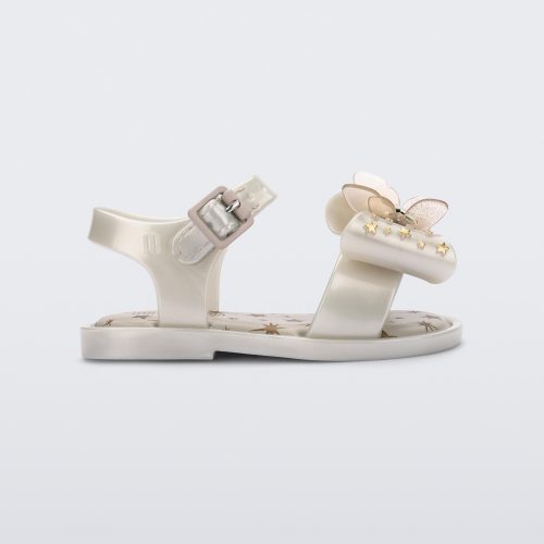 Side view of the Mini Melissa Mar Sandal with star print for baby in white with butterfly bow applique and velcro closure on ankle strap.