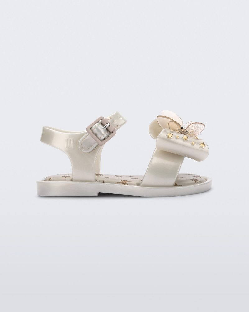 Side view of the Mini Melissa Mar Sandal with star print for baby in white with butterfly bow applique and velcro closure on ankle strap.