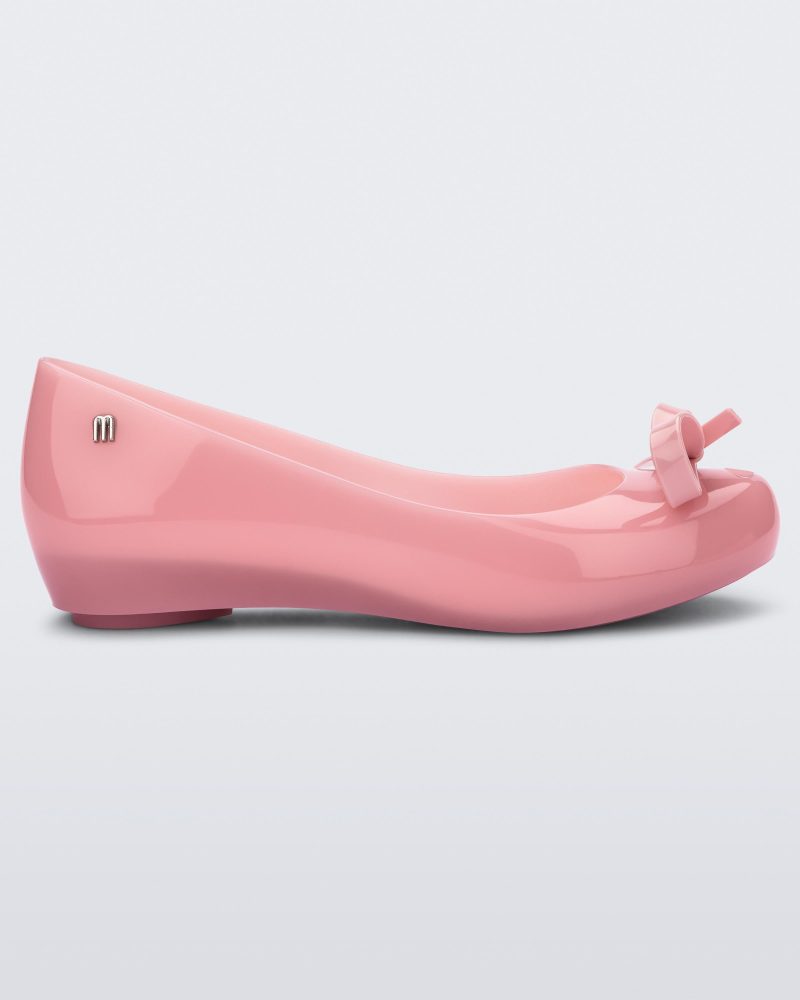 Side view of a pink Ultragirl bow flat