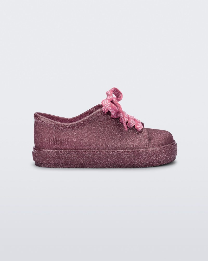 Side view of a glitter pink baby Hip M Lover sneaker with laces