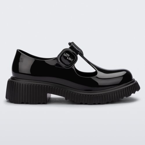 Side view of a black Mini Melissa Jackie loafer with two cut outs and a buckle detail strap.