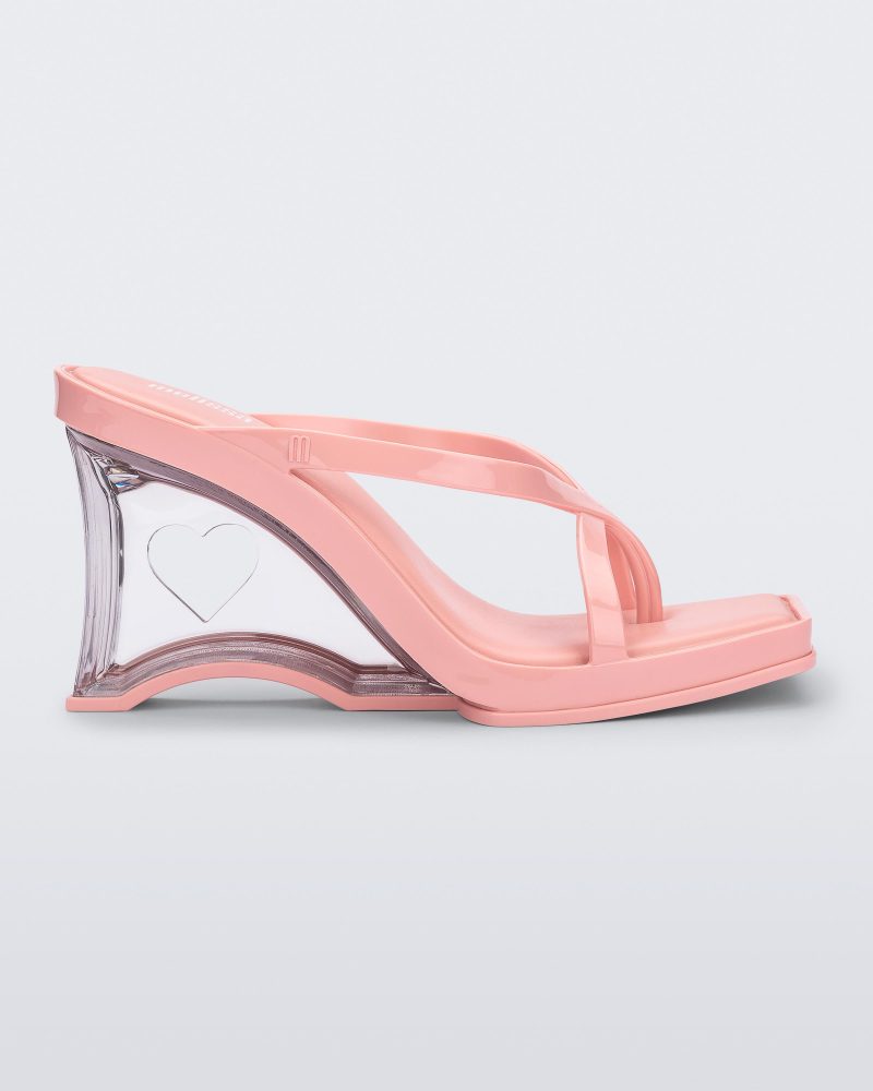 Side view of a pink Glass Heel with a heart cutout in the heel.