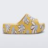 Side view of a yellow Free Print Platform slide with a white and blue flower print.