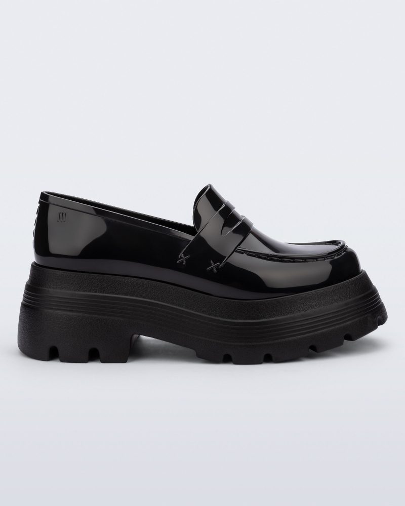 Side view of a black Royal High + Undercover platform loafer.