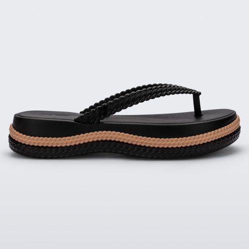 Side view of a black/beige Melissa Leblon platform flip flop with details that mimic sisal braids on the sole and strap