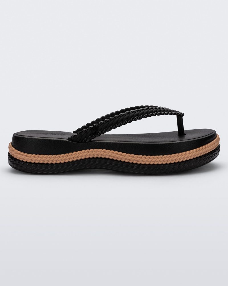 Side view of a black/beige Melissa Leblon platform flip flop with details that mimic sisal braids on the sole and strap