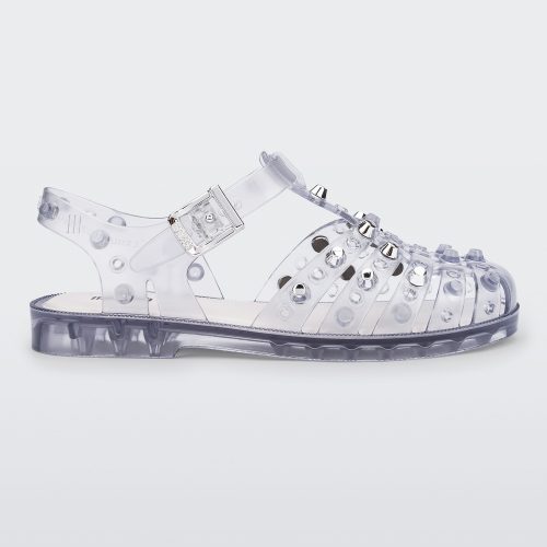 Side view of a clear Possession Studs fisherman sandal with silver studs.