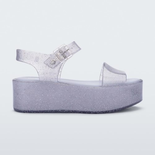 Side view of a glitter lilac Melissa platform sandal with a front and ankle strap