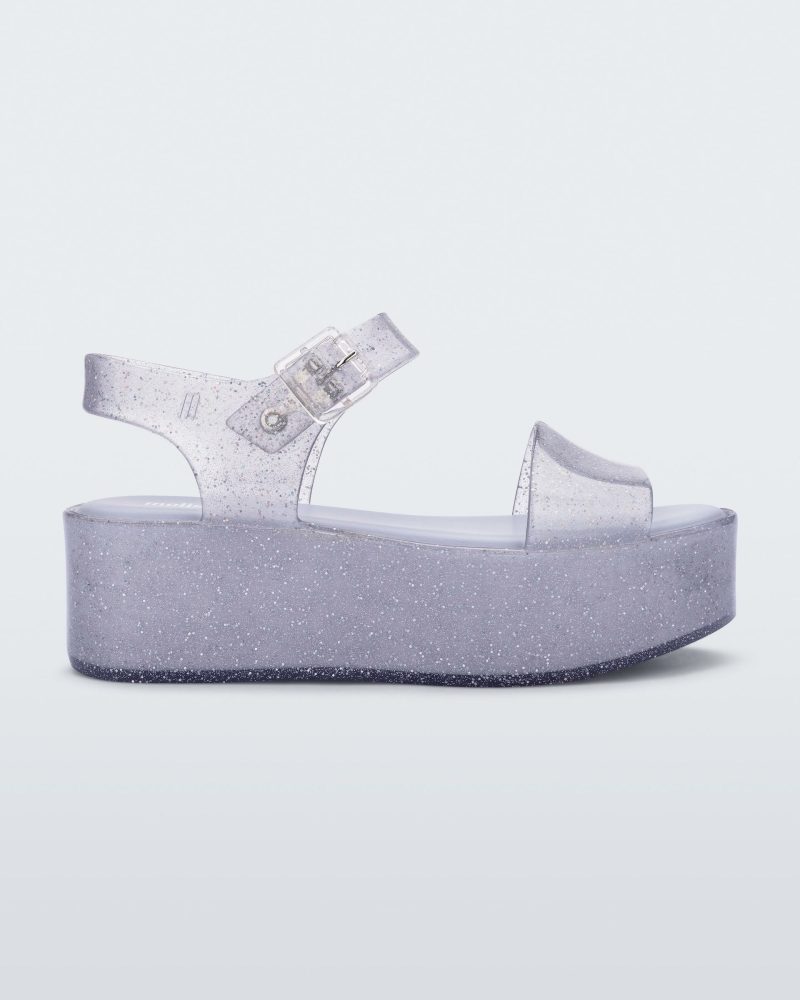 Side view of a glitter lilac Melissa platform sandal with a front and ankle strap