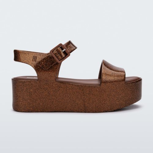 Side view of a bronze Melissa platform sandal with a front and ankle strap