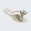 An angled top view of a White/Gold Glitter Mini Melissa Harmonic Bow flip flop with a white sole, straps and gold glitter bow.