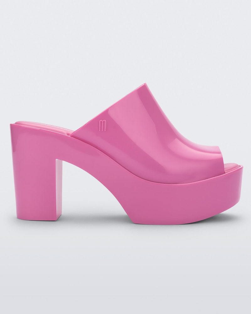 Side view of a pink Melissa Mule platform heel.