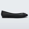 Side view of a black Melissa flat with a black bow detail with metallic accents on the toe