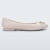 Side view of a light beige Melissa flat with a beige bow detail with gold accents on the toe