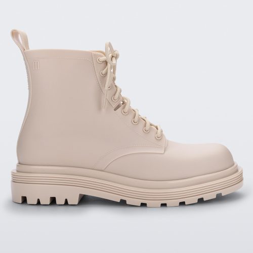 Side view of a beige Melissa Coturno boot.