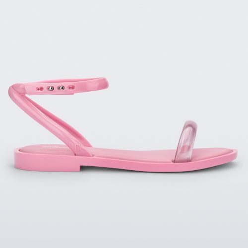 Side view of a pink Melissa Wave Sandal with a clear pink front strap and a pink ankle strap and sole.