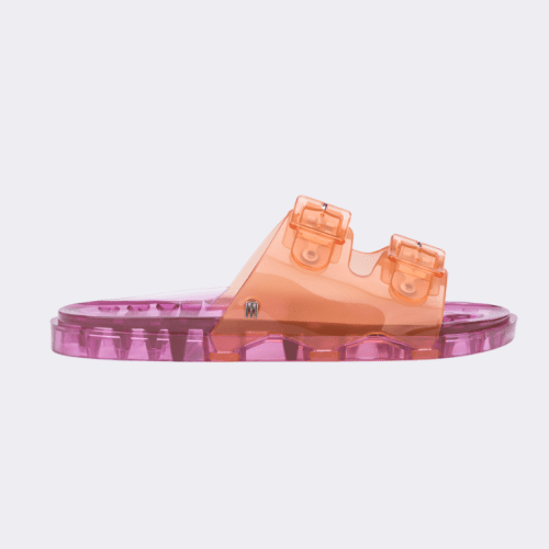 Side view of a Melissa Wide slide sandal with pink sole and two orange front straps