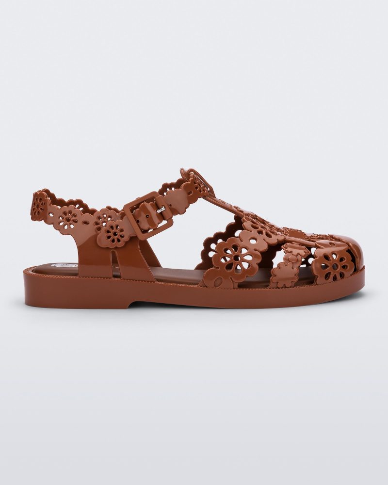 Side view of a Melissa Possession fisherman sandal in brown with cut out lace detail on the straps.