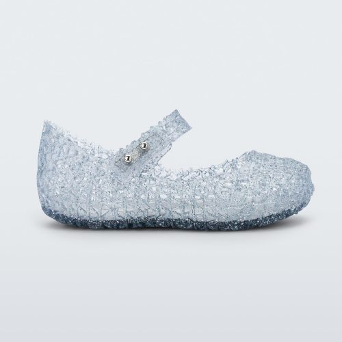 Side view of Mini Melissa Campana clear glitter flats with a snap strap for baby with an open woven texture