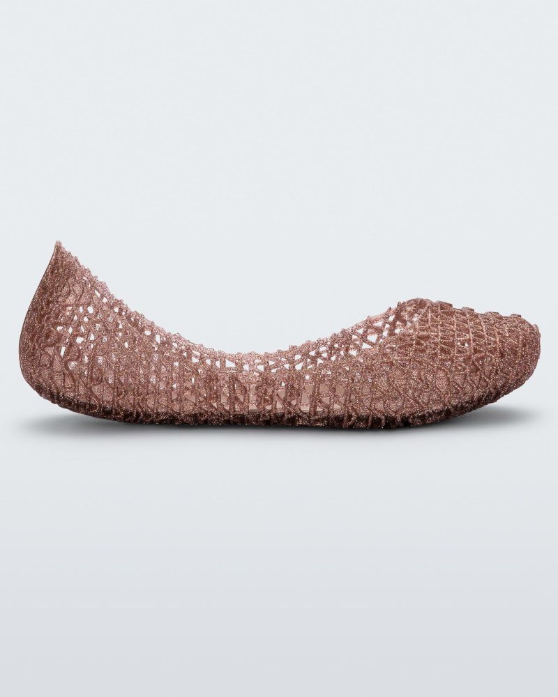 An outter side view of a rose glitter Mini Melissa Campana flats with a woven detail base.