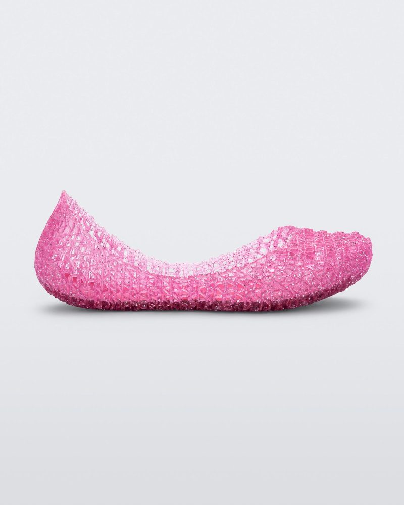 Side view of a pink Mini Melissa Campana flat with a woven detail base.