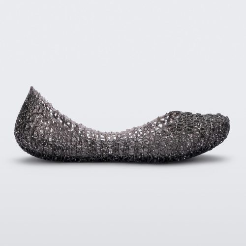 Side view of a black Mini Melissa Campana flat with a glitter design and an open woven texture.