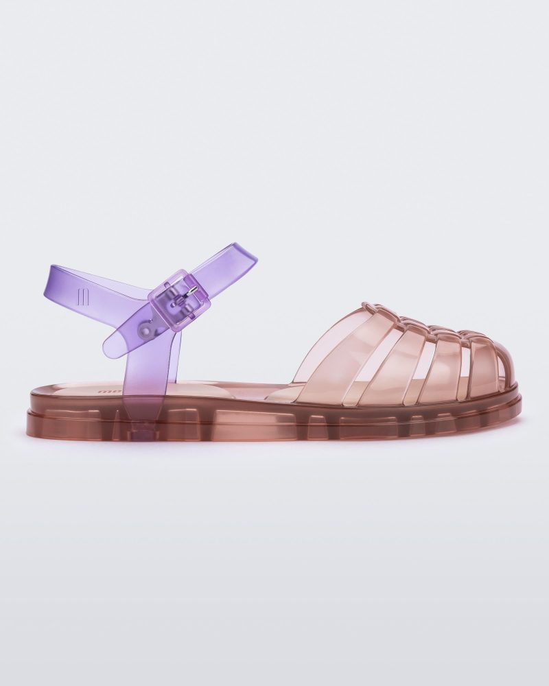 Side view of a transparent pink and purple Melissa Obsessed sandal.