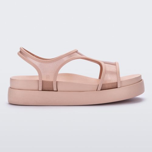 Side view of a transparent pink glitter Melissa Bikini Platform sandal with two transparent pink glitter straps conjoining in the middle and a pink sole.