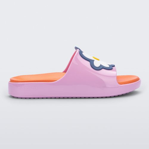 Side view of a pink/orange Mini Melissa Cloud slide with an orange insole, pink base and a flower detail on the front.