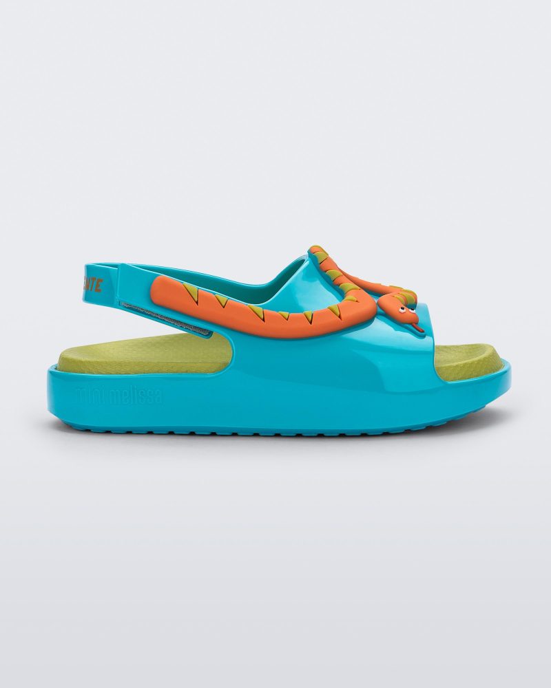 Side view of a blue/green Mini Melissa Cloud sandal with a velcro back strap, a green insole, blue base and orange snake detail on the front.