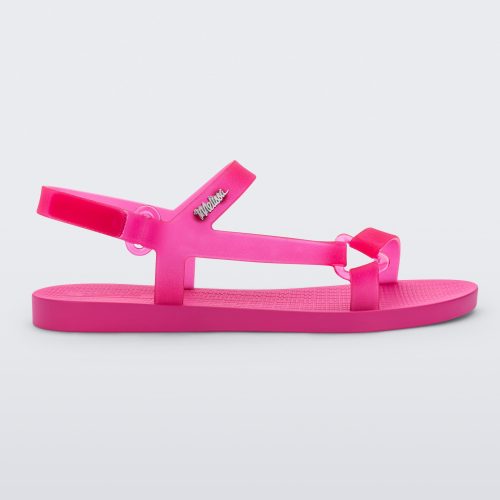 Side view of a Melissa Sun Downtown sandal with transparent pink front cross and back ankle straps and a pink sole.