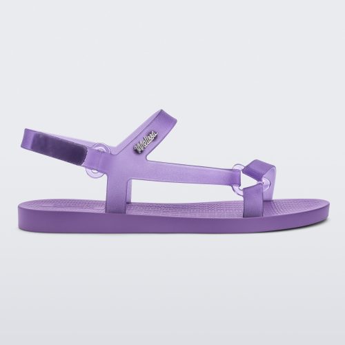 Side view of a Melissa Sun Downtown sandal with transparent lilac front cross and back ankle straps and a lilac purple sole. 