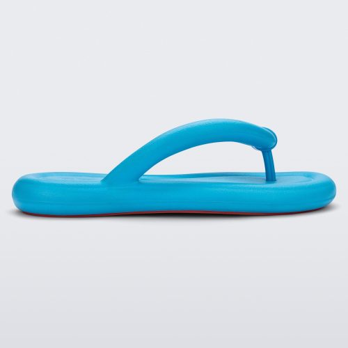 Side view of a sky blue Melissa Free Flip Flop with puffer-like straps.