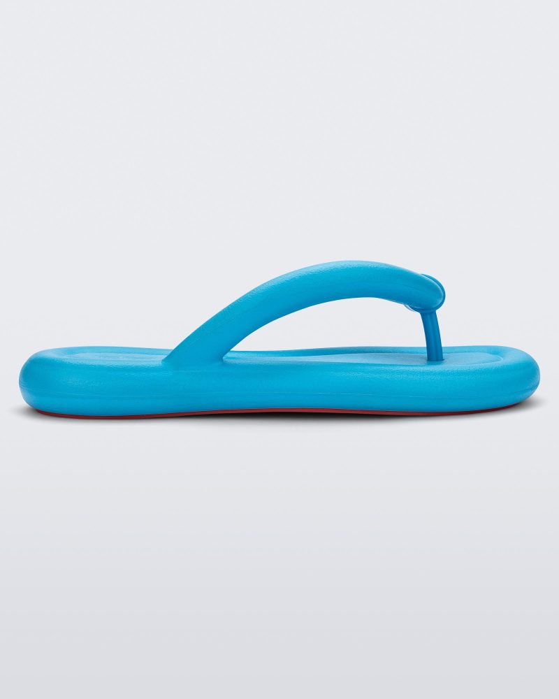 Side view of a sky blue Melissa Free Flip Flop with puffer-like straps.