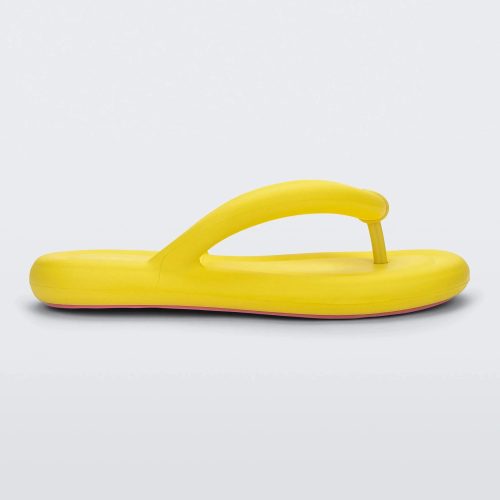 Side view of a yellow Melissa Free Flip Flop with puffer-like straps.