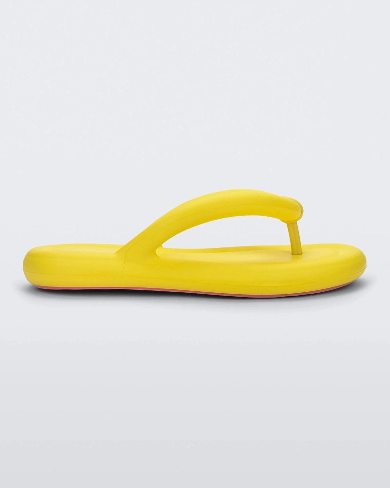 Side view of a yellow Melissa Free Flip Flop with puffer-like straps.