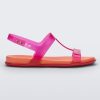 Side view of a pink / orange Melissa Adore sandal with two translucent pink straps, joined together by a third strap and an orange insole.