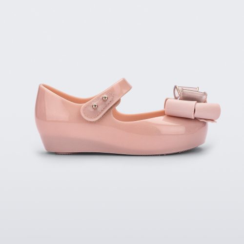 Side view of a Pink Glitter/Beige Mini Melissa Ultragirl Sweet flat with a top strap and bow detail on the toe.