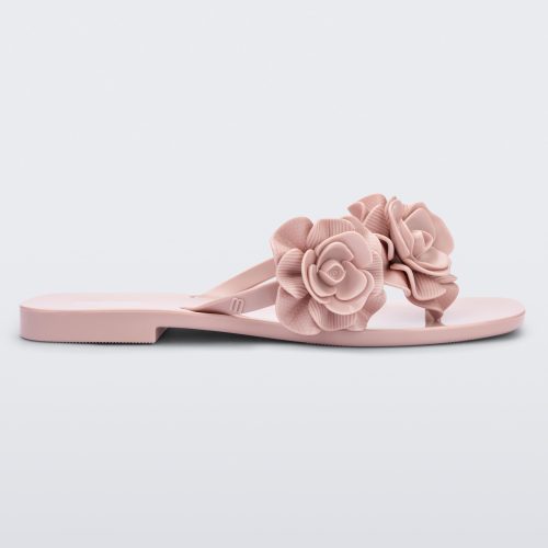 Side view of a light pink Melissa Harmomic Squared Garden flip flop with flowers on the straps.