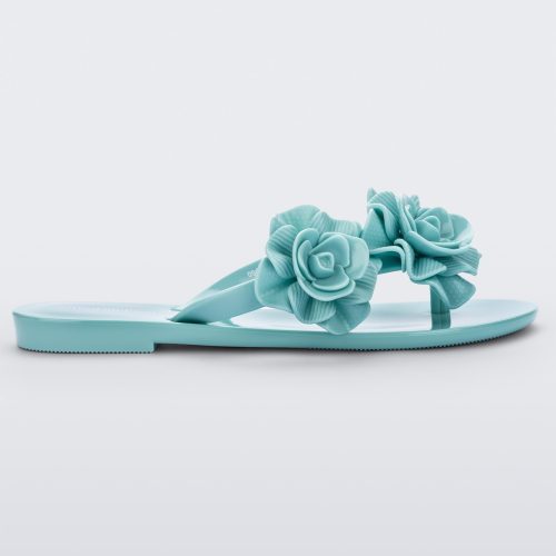 Side view of a green Melissa Harmomic Squared Garden flip flop with flowers on the straps.