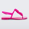 Side view of a pink Melissa Harmonic Squared Garden sandal with a flower decoration on the front strap.