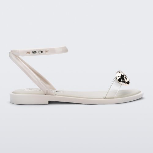 Side view of a white Melissa Dare sandal with a silver metal chain buckle.