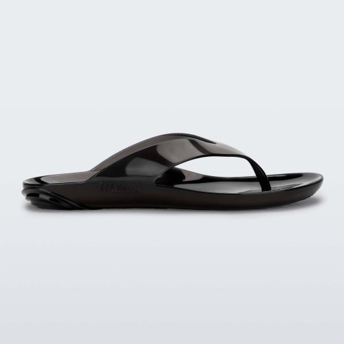 Side view of a clear black Melissa Real Jelly Flip Flop.